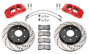 Wilwood front AERODM brake kit for Ford F-150 SVT Raptor: Two red-finish AERODM calipers with drilled and slotted one-piece rotors, brake pads and mounting fasteners, braided hoses and fittings laid out.