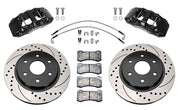Wilwood front AERODM brake kit for Ford F-150 SVT Raptor: Two black AERODM calipers with drilled and slotted one-piece rotors, brake pads and mounting fasteners, braided hoses and fittings laid out.