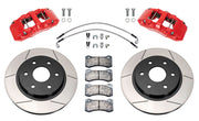 Wilwood front AERODM brake kit for Ford F-150 SVT Raptor: Two red-finish AERODM calipers with slotted one-piece rotors, brake pads and mounting fasteners, braided hoses and fittings laid out.