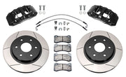 Wilwood front AERODM brake kit for Ford F-150 SVT Raptor: Two black AERODM calipers with slotted one-piece rotors, brake pads and mounting fasteners, braided hoses and fittings laid out.