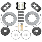 Wilwood front AERO6 brake kit for Mustang road-race package: Parts layout with two gray anodized AERO6 calipers, slotted rotor rings, separate silver hats, pads, brackets and fasteners, with braided hoses.