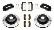 Wilwood rear TX4R brake kit for GM truck factory parking-brake arrangement: Two black TX4R calipers with drilled and slotted one-piece rotors, brake pads and mounting fasteners, with separate caliper mounting brackets.