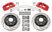 Wilwood front AERODM brake kit for Ford F-150 2021–2025: Two red-finish AERODM calipers with drilled and slotted one-piece rotors, brake pads and mounting fasteners, braided hoses and fittings laid out.