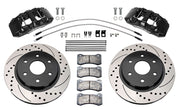 Wilwood front AERODM brake kit for Ford F-150 2021–2025: Two black AERODM calipers with drilled and slotted one-piece rotors, brake pads and mounting fasteners, braided hoses and fittings laid out.
