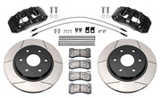 Wilwood front AERODM brake kit for Ford F-150 2021–2025: Two black AERODM calipers with slotted one-piece rotors, brake pads and mounting fasteners, braided hoses and fittings laid out.
