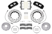 Wilwood front SX6R brake kit for Corvette C8: Parts layout with two black SX6R calipers, drilled and slotted rotor rings, separate silver hats, pads, brackets and fasteners, with braided hoses.