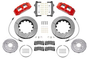 Wilwood front SX6R brake kit for Corvette C8: Parts layout with two red-finish SX6R calipers, slotted rotor rings, separate silver hats, pads, brackets and fasteners, with braided hoses.