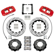 Wilwood front AERO6 brake kit for Porsche 996/997 and Boxster/Cayman: Parts layout with two red-finish AERO6 calipers, drilled and slotted rotor rings, separate black hats, pads, brackets and fasteners, with braided hoses.