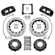 Wilwood front AERO6 brake kit for Porsche 996/997 and Boxster/Cayman: Parts layout with two black AERO6 calipers, drilled and slotted rotor rings, separate black hats, pads, brackets and fasteners, with braided hoses.
