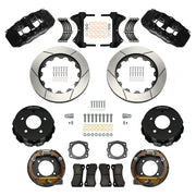 Wilwood Chevrolet and GMC C1500 rear brake kit with black AERO4 calipers and 14.00-inch slotted rotors, laid out with parking-shoe assemblies, hats, pads, brackets and fasteners