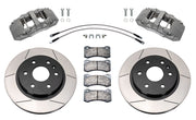 Wilwood GM armored-vehicle front brake kit with anodized AERODM calipers and 13.38-inch slotted rotors, laid out with TX1 pads, flexlines and mounting fasteners