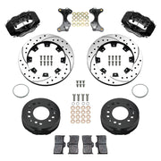 Wilwood aluminum ProSpindle front brake kit with black Dynalite calipers and 12.19-inch drilled and slotted rotors, laid out with hats, registration rings, pads, brackets and fasteners