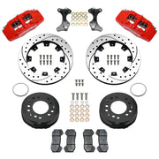 Wilwood aluminum ProSpindle front brake kit with red DP6A calipers and 12.19-inch drilled and slotted rotors, laid out with hats, registration rings, pads, brackets and fasteners