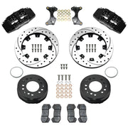 Wilwood aluminum ProSpindle front brake kit with black DP6A calipers and 12.19-inch drilled and slotted rotors, laid out with hats, registration rings, pads, brackets and fasteners