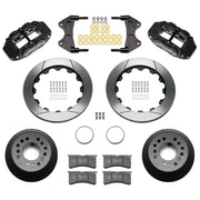 Wilwood aluminum ProSpindle front brake kit with black FNSL6R calipers and 12.88-inch slotted rotors, laid out with hats, registration rings, pads, brackets and fasteners