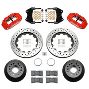 Wilwood aluminum ProSpindle front brake kit with red FNSL6R calipers and 14.00-inch drilled and slotted rotors, laid out with hats, registration rings, pads, brackets and fasteners
