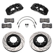 Components laid out for the Wilwood front AERO6-DM brake kit for Toyota Tacoma, SRP drilled and slotted rotors and black powder coat calipers