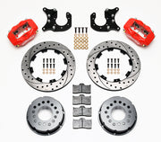 Components laid out for the Wilwood rear Dynalite Pro Series brake kit for Ford Mustang 8.8-Inch Five-Lug Axles, SRP drilled and slotted rotors and red powder coat calipers