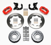 Components laid out for the Wilwood rear Dynalite Pro Series brake kit for Ford Mustang 8.8-Inch Five-Lug Axles, plain face rotors and red powder coat calipers