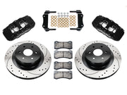Wilwood black AERO4 rear brake kit with 14.25-inch drilled and slotted rotors, calipers and mounting components laid out