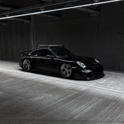 Rennline Carbon Fiber Aerokit Front Lip - 997: Hand-laid carbon fiber, high gloss finish, and OEM fit for enhanced style and performance. Shop now at PMB.