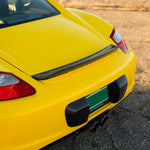 Rennline Carbon Fiber Upkick Spoiler: Elevate your 987 Cayman with this sleek, hand-laid carbon fiber spoiler for an OEM+ look. Shop now at PMB Performance.