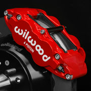 Wilwood right FNSL6R-DS red caliper, 1.10-inch rotor width, 1.62/1.12/1.12-inch bores: mounted around a drilled rotor beside the hub
