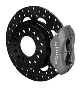 Wilwood rear gray Dynalite caliper beside an 11.44-inch drilled rotor, angled assembly for Small Ford 2.66-inch offset