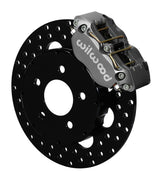 Wilwood front gray Narrow Dynapro caliper beside an 11.75-inch drilled rotor, angled assembly for Mustang disc-spindle drag setup