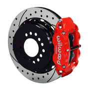 Wilwood rear red Superlite 4R caliper beside a 12.88-inch drilled/slotted rotor, angled assembly for large C10 2.42-inch-offset axle