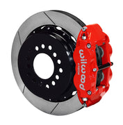 Wilwood rear red Superlite 4R caliper beside a 12.88-inch slotted rotor, angled assembly for large C10 2.42-inch-offset axle