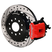 Wilwood rear red CPB caliper beside a 12.88-inch drilled/slotted rotor, angled assembly for Mustang solid axle, 3.25-inch offset
