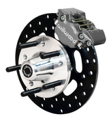 Wilwood front gray Dynapro Single caliper beside a 10.00-inch drilled rotor, angled assembly for GM/Ford pin-spindle drag setup