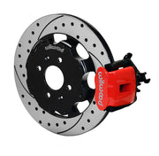 Wilwood rear red CPB caliper beside a 12.19-inch drilled/slotted rotor, angled assembly for Honda/Acura original-disc hub arrangement