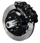 Wilwood front black Superlite 6R caliper beside a 12.88-inch slotted rotor, angled assembly for early Ford/Mercury disc spindles