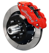 Wilwood front red Superlite 6R caliper beside a 12.88-inch slotted rotor, angled assembly for later Ford/Mercury disc spindles