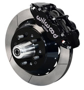 Wilwood front black Superlite 6R caliper beside a 12.88-inch slotted rotor, angled assembly for later Ford/Mercury disc spindles