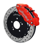 Wilwood front red Superlite 6R caliper beside a 12.88-inch drilled/slotted rotor, angled assembly for S2000 front hub arrangement