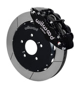 Wilwood front black Superlite 6R caliper beside a 12.88-inch slotted rotor, angled assembly for S2000 front hub arrangement