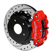 Wilwood rear red Superlite 4R caliper beside a 12.88-inch drilled/slotted rotor, angled assembly for Corvette C2/C3 original parking mechanism