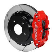 Wilwood rear red Superlite 4R caliper beside a 12.88-inch slotted rotor, angled assembly for Corvette C2/C3 original parking mechanism