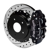 Wilwood rear black Superlite 4R caliper beside a 14.00-inch drilled/slotted rotor, angled assembly for Corvette C2/C3 large rear rotor setup