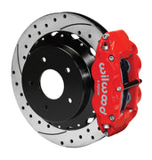 Wilwood rear red Superlite 4R caliper beside a 14.00-inch drilled/slotted rotor, angled assembly for Corvette C2/C3 large rear rotor setup