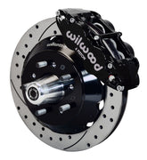 Wilwood front black Superlite 6R caliper beside a 12.88-inch drilled/slotted rotor, angled assembly for early GM factory disc spindle