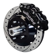 Wilwood front black Superlite 6R caliper beside a 14.00-inch drilled/slotted rotor, angled assembly for early GM large-rotor front setup