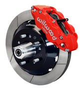 Wilwood front red Superlite 6R caliper beside a 14.00-inch slotted rotor, angled assembly for later GM large-rotor hub arrangement