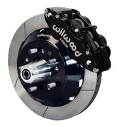 Wilwood front black Superlite 6R caliper beside a 14.00-inch slotted rotor, angled assembly for later GM large-rotor hub arrangement
