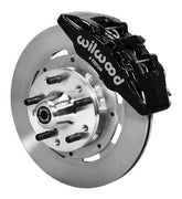 Wilwood front black Dynapro 6 caliper beside a 12.19-inch plain-face rotor, angled assembly for GM/Ford pin-spindle six-piston setup