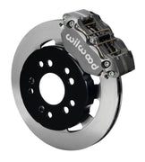 Wilwood front gray Narrow Dynapro caliper beside an 11.75-inch plain-face rotor, angled assembly for later Mustang front drag arrangement