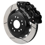 Wilwood front black Superlite 6R caliper beside a 13.06-inch slotted rotor, angled assembly for Corvette C2/C3 front hub setup